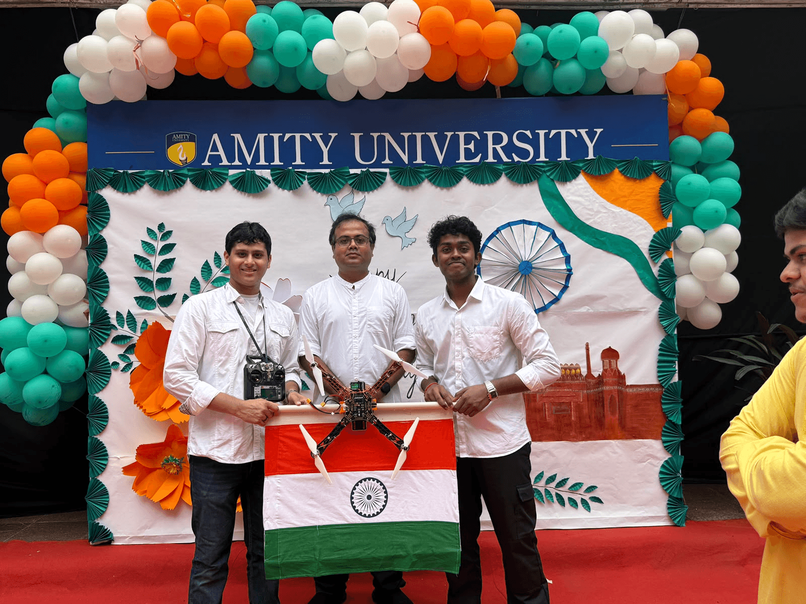 A team with a quadcopter, radio controller and Indian flag at an Amity University celebration